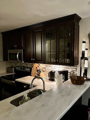 The kitchen and the  bar area in the evening.  A newly remodeled kitchen