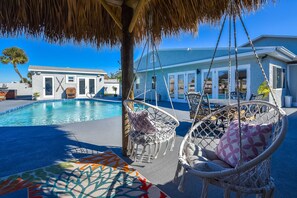 Sit and relax in the hanging chairs after a dip in the pool.