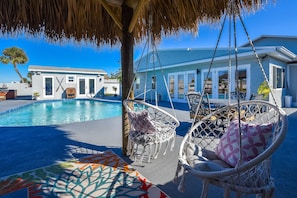 Sit and relax in the hanging chairs after a dip in the pool.