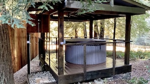 A hot shower is located adjacent to the hot tub for a quick rinse.