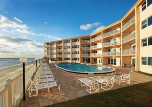 Step outside and take a dip in the sparkling pool, lounge under the sun, or sip on a refreshing drink while enjoying the perfect coastal atmosphere.