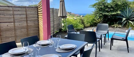 Terrasse avec table à manger, mobilier de jardin, barbecue et piscine privée