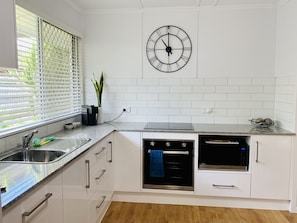 Newly renovated kitchen with coffee pod machine, oven and microwave. 
