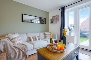 A cosy living room equipped with a large comfortable sofa and Smart TV with Netflix subscription included