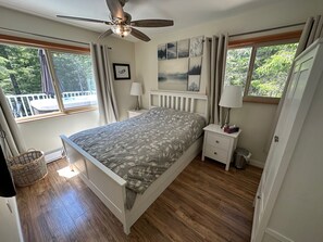 Primary Bedroom with queen bed side tables, mirror, 52 inch TV, wardrobe, 2 bath