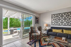 Living room leading to private pool and spa.