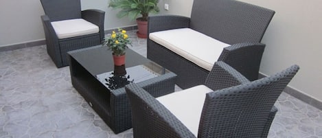 Balcony with rattan table and chairs