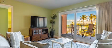 Living room and balcony overlooking the pool, tennis courts and Gulf views!