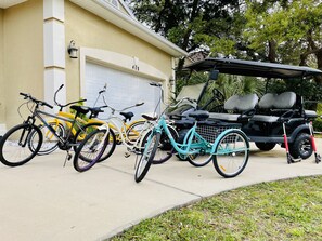 6 Seater Golf cart, Tandem bike, trike, 2 traditional bikes, and 2 kid scooters 