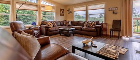 Spacious living area with TV and sliding glass door to outside