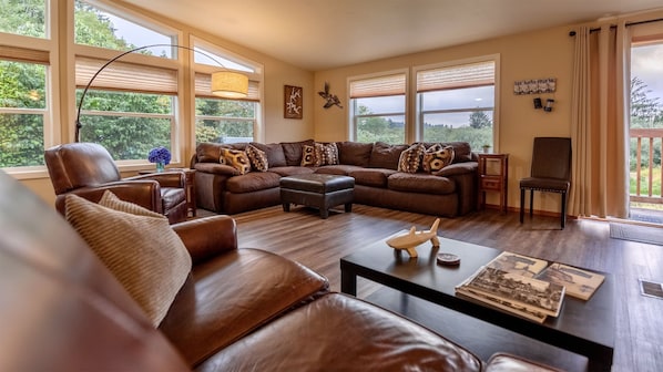 Spacious living area with TV and sliding glass door to outside