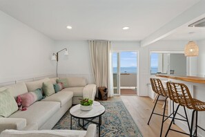 The living room has recessed lighting with a dimmer switch.