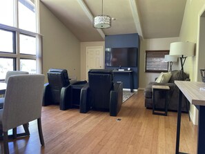 The open living area has a smart TV, 2 recliners and a pull out sofa.