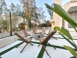 Lounge by the gas fire pit after a long day.