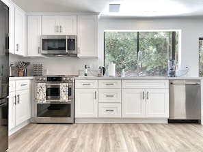 Newly renovated chef’s kitchen provides an informal area for socialization.