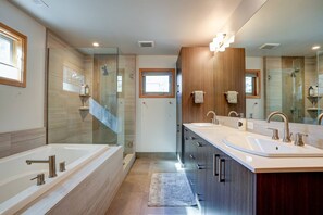 Master ensuite with soaking tub, walk-in shower, and dual sinks.