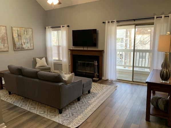 View of the living room.  We have a 55 in streaming capable smart TV mounted over the fireplace.