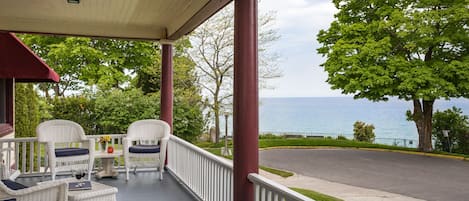 Covered front porch with views of Lake Michigan and the sunset over the water