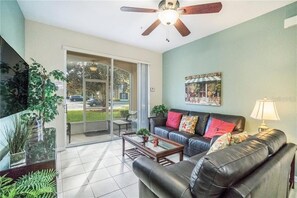 Living room with new leather couches and decor 55" TV