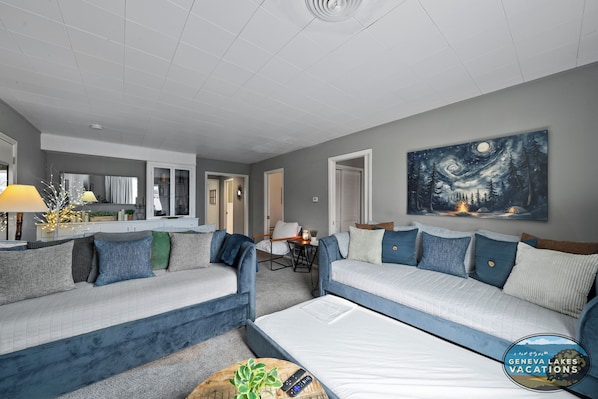Main living room area for the two units with two twin daybeds with trundles. Perfect for gathering!