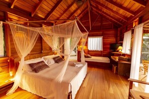 Auburn wood and cozy lighting create an intimate ambiance around the luxurious bed
