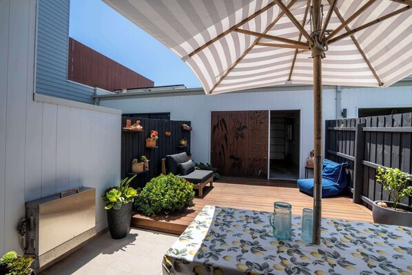 Enjoy the sunny outdoor living space on the private deck with a BBQ and lounge area