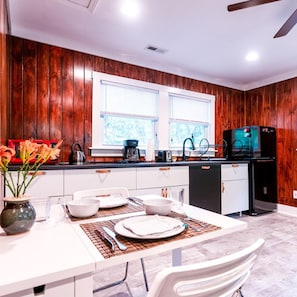 The table in the kitchen area can fold down and out of the way or seat six.