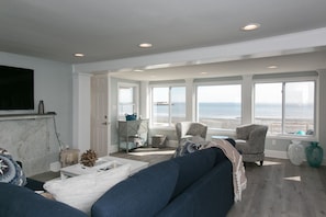 Living room with direct view of and access to Long Island Sound.