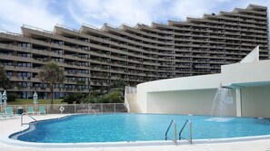 Looking up at the units from the pool