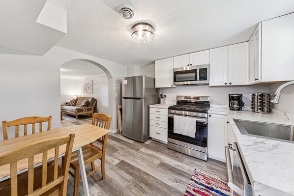 Downstairs kitchen featuring new appliances.