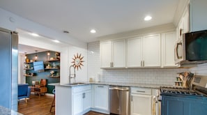 Full kitchen includes pots/pans, cooking utensils, dishware/glassware