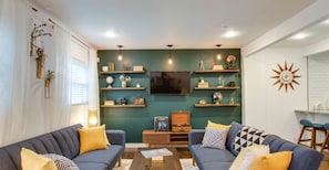 Mid-century open living space + two fold out couches that convert to futons