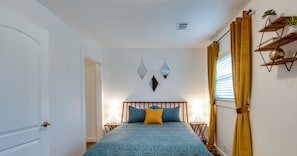 Luxurious master bedroom with cozy queen bed and plush pillows