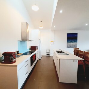 Fully equipped kitchen with 900mm oven and stove top, dishwasher, coffee machine