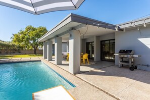 Large covered outdoor patio w/ Weber gas grill.