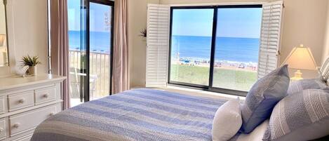Relax in the master bedroom with beautiful ocean views and access to the balcony
