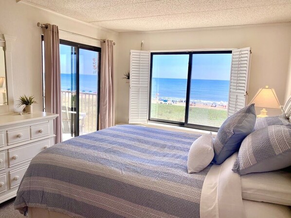 Relax in the master bedroom with beautiful ocean views and access to the balcony