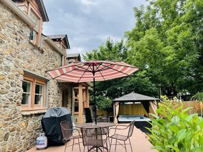 Deck out the back door with grill & table for taking a leisurely moment