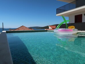 Water, Sky, Building, Azure, Swimming Pool, Body Of Water, House, Leisure, Aqua, Resort Town