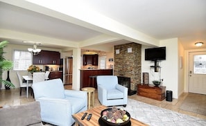 Open-concept living space including living room, kitchen and dining room