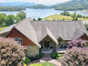 Front view of property and lake just beyond