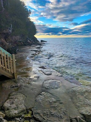 Amazing rock patio at the waterfront to hang out with chairs, grill out, fish from!