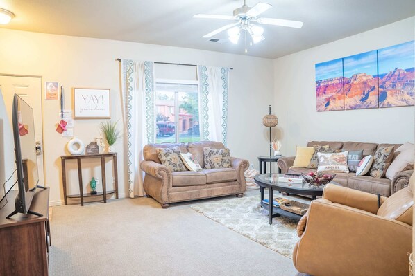 Living room with comfortable couches and a luxurious massage chair!