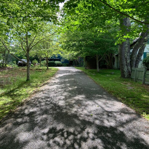 Driveway view of property in Spring/Summer.