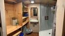 View of the bathroom with galvanized metal shower. Inside the tiny house!
