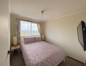 Queen bedroom with TV.