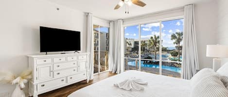 Master Bedroom with large flat screen, king size bed, view of the pool and Gulf.