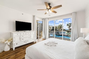 Master Bedroom with large flat screen, king size bed, view of the pool and Gulf.