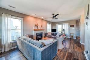 Living room with view of front porch, entry door and half bath