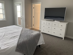 Master bedroom, bed, TV, bathroom and veranda.